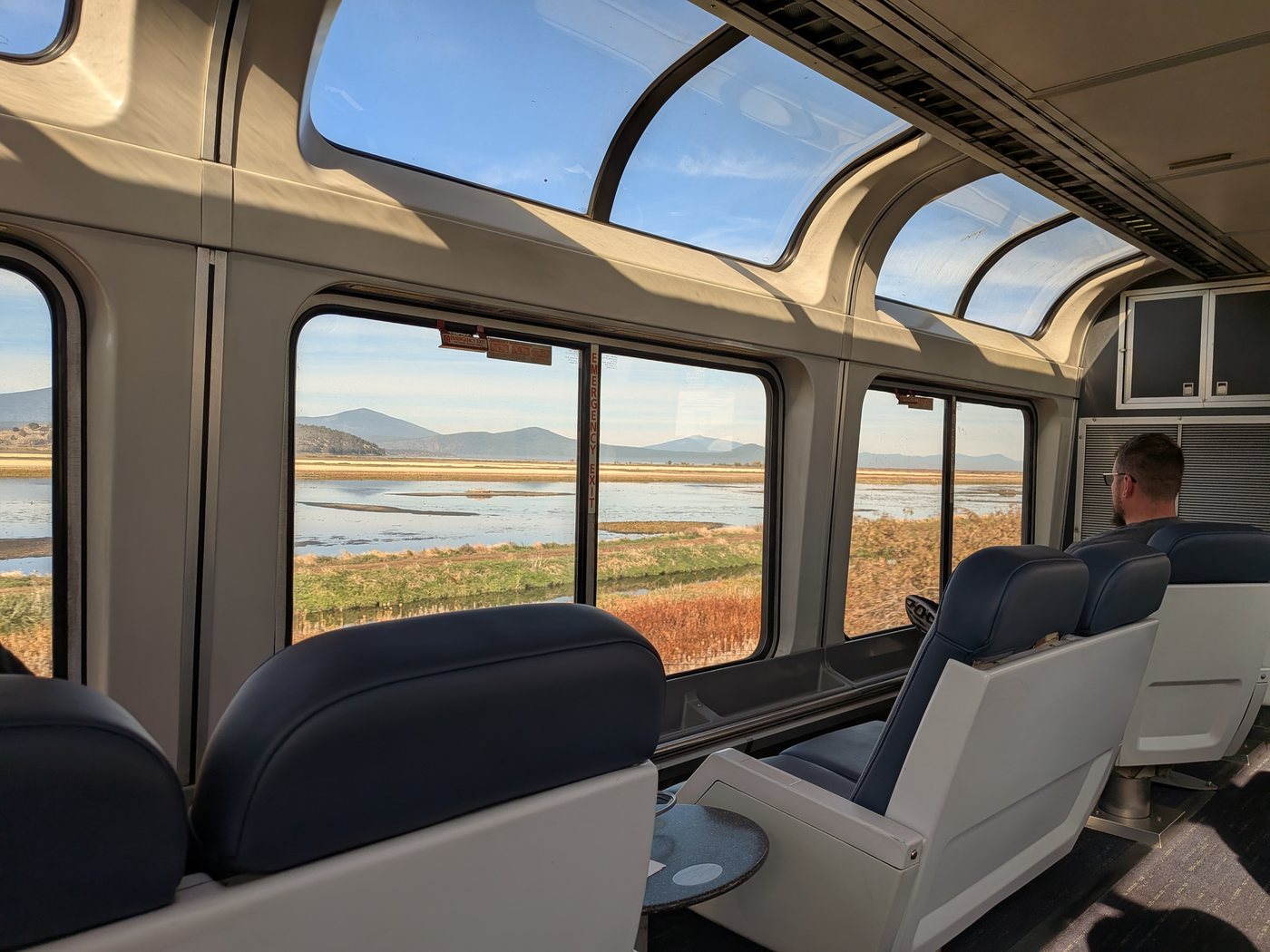The train’s observation car, with marshes and mountains through the windows