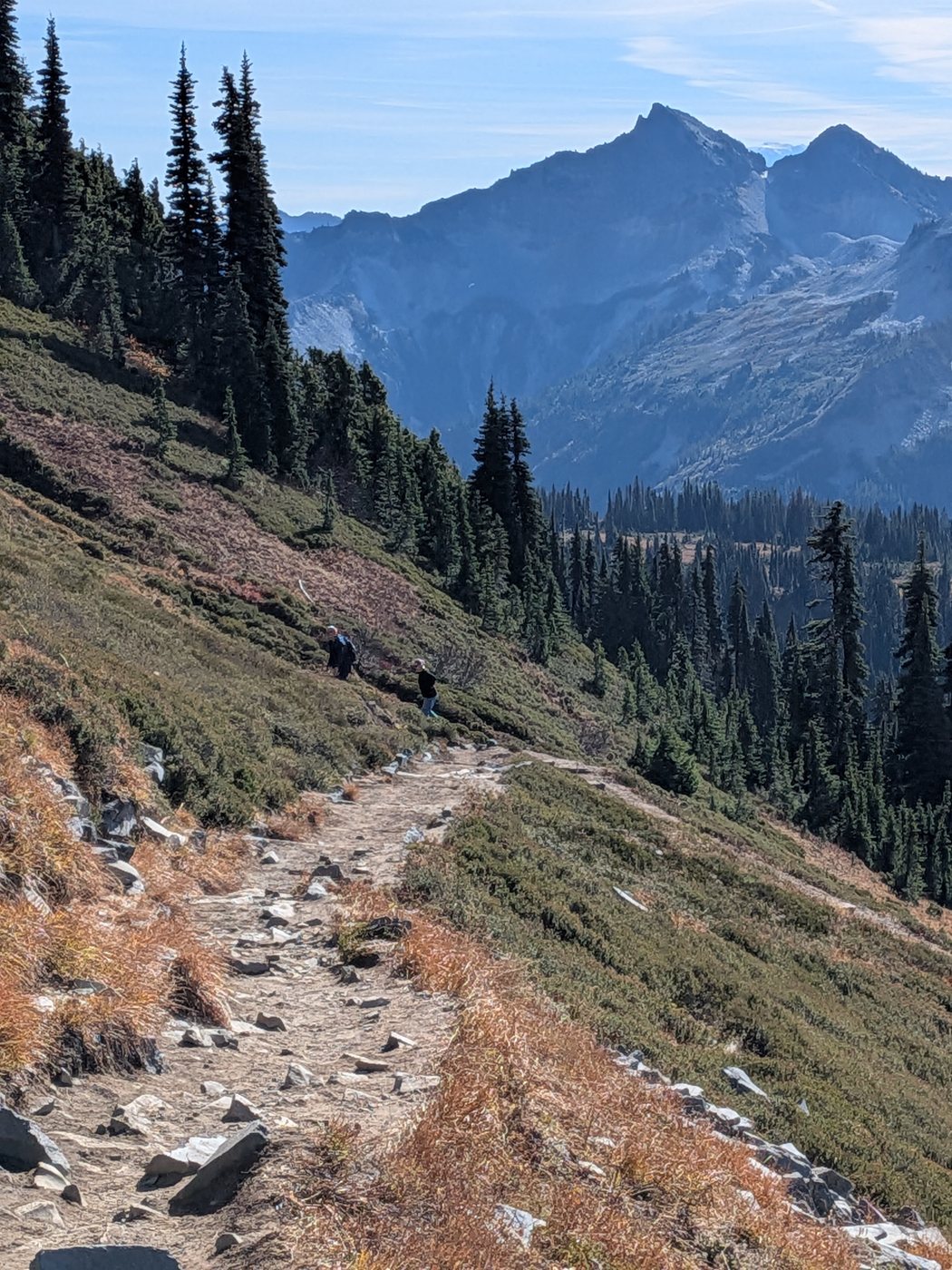 A rocky trail across a slope toward jagged peaks